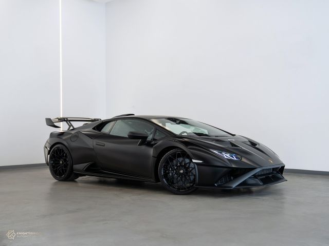 New 2022 Lamborghini Huracan STO Matte Black exterior with Red and Black interior at Knightsbridge Automotive